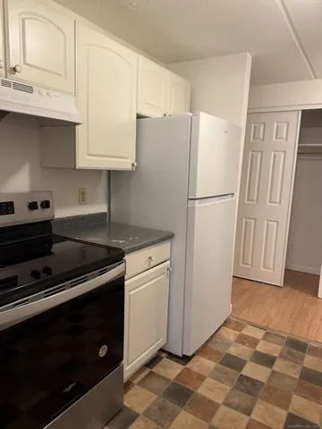a white refrigerator freezer sitting inside of a kitchen