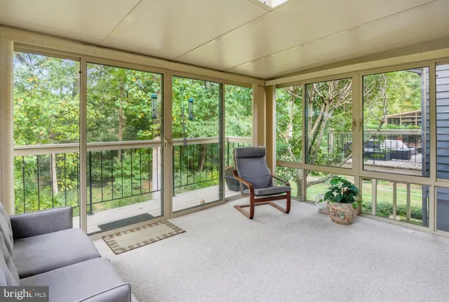 a living room with furniture and a garden