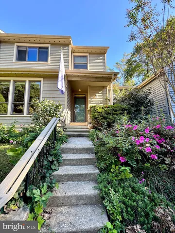a view of a house with potted plants