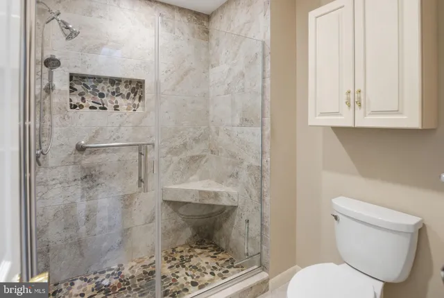 a bathroom with a toilet and a shower