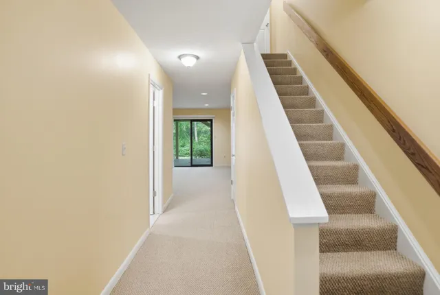 a kitchen with a checkered floor and white cabinets