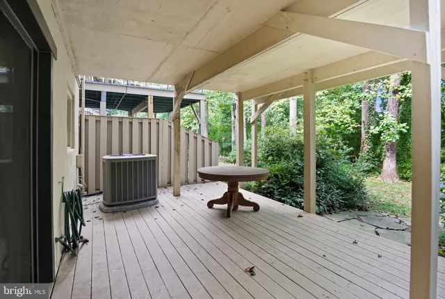a bathroom with a granite countertop toilet a sink and a mirror