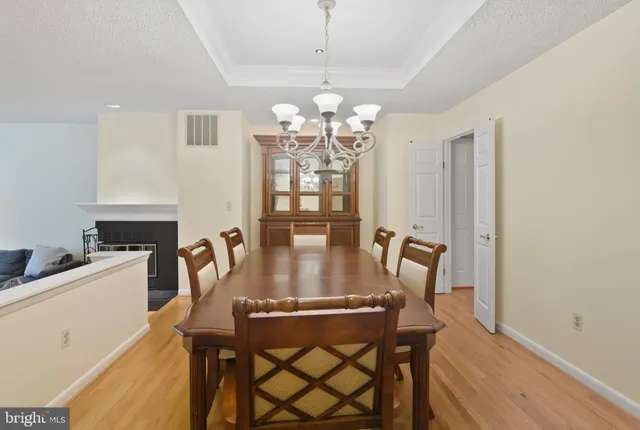 a view of a dining room with furniture and chandelier