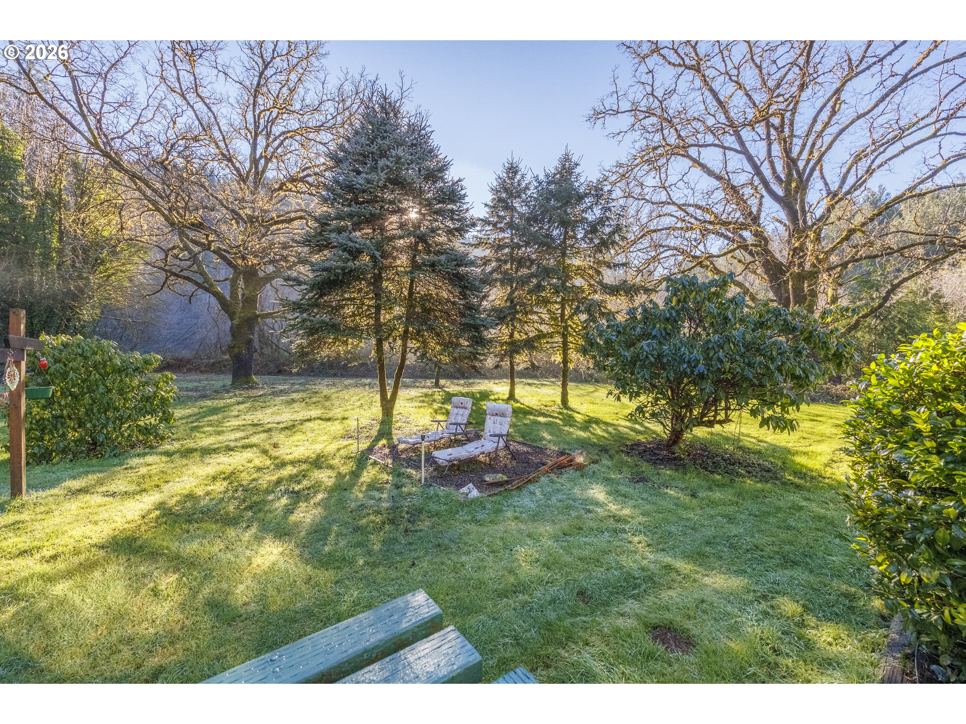 9580 North Fork Siuslaw Road Florence, OR 97439 - Photo 13 of 48 a backyard of a house with table and chairs