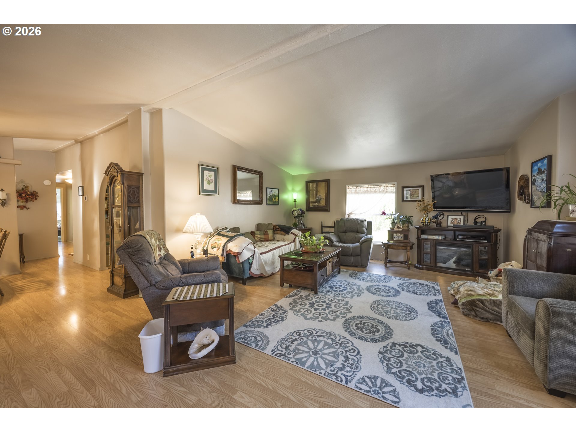 9580 North Fork Siuslaw Road Florence, OR 97439 - Photo 16 of 48 a living room with furniture flat screen tv and a fireplace