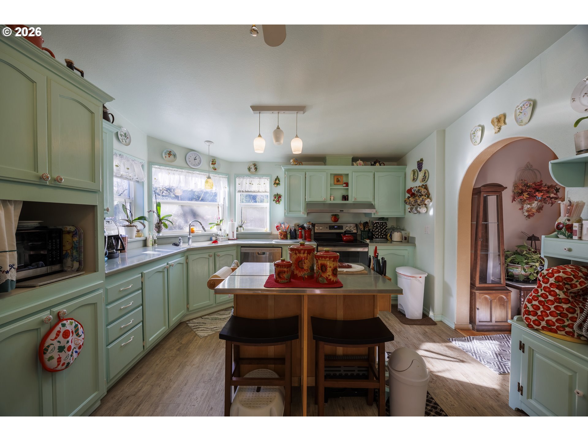 9580 North Fork Siuslaw Road Florence, OR 97439 - Photo 30 of 48 a kitchen with stainless steel appliances a stove a sink cabinets and a dining table