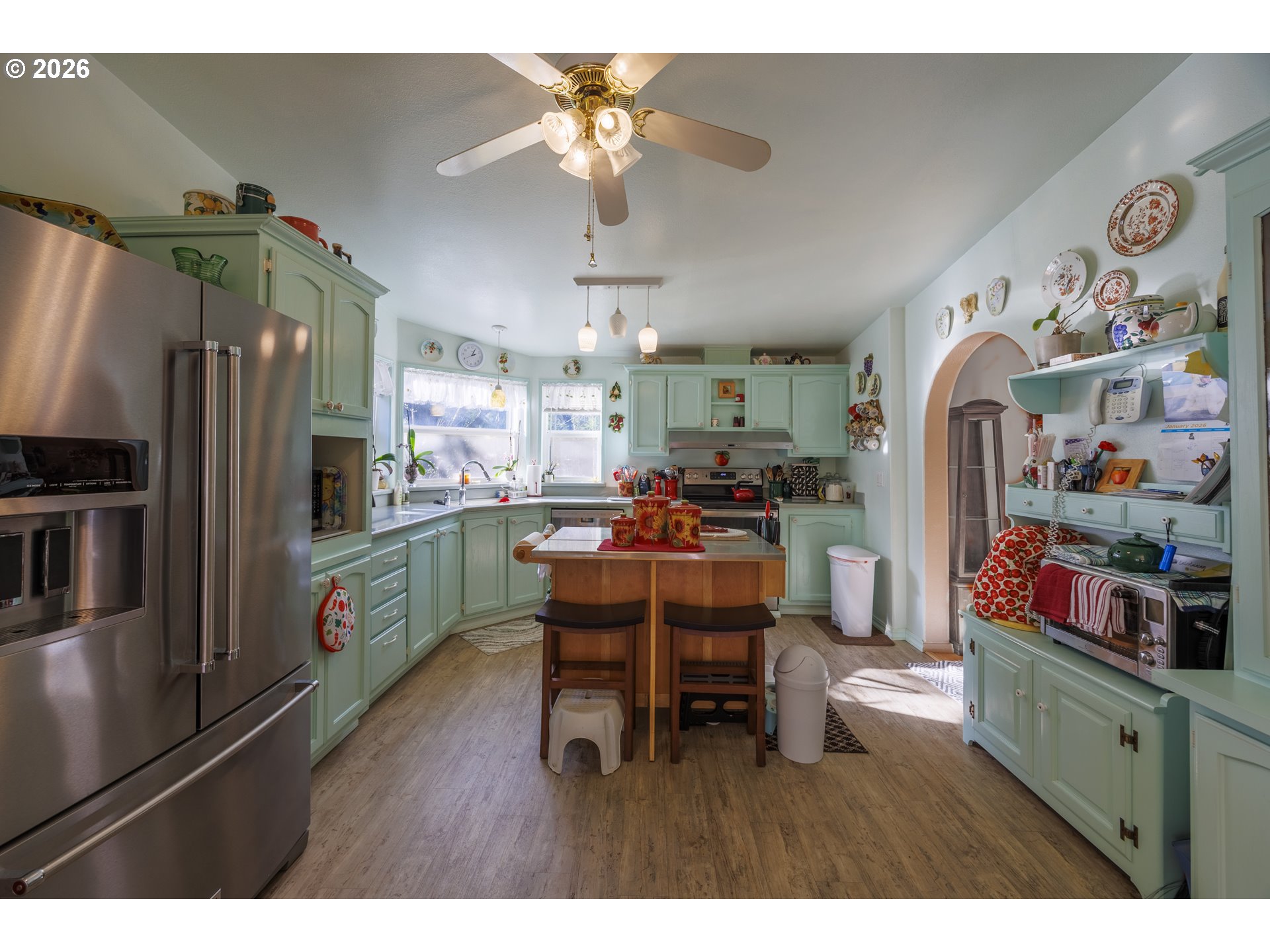 9580 North Fork Siuslaw Road Florence, OR 97439 - Photo 31 of 48 a kitchen with stainless steel appliances a table chairs and a refrigerator