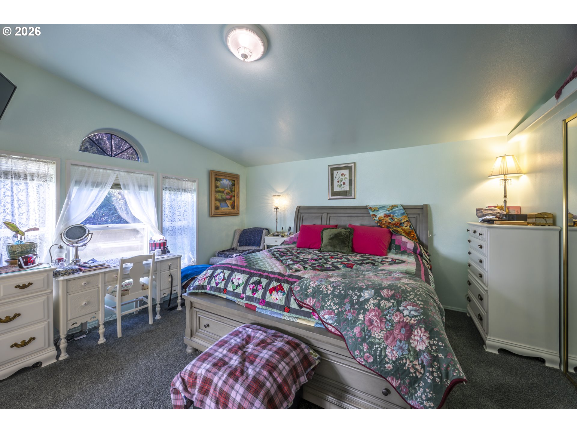 9580 North Fork Siuslaw Road Florence, OR 97439 - Photo 38 of 48 a bedroom with a bed a dresser next to a window
