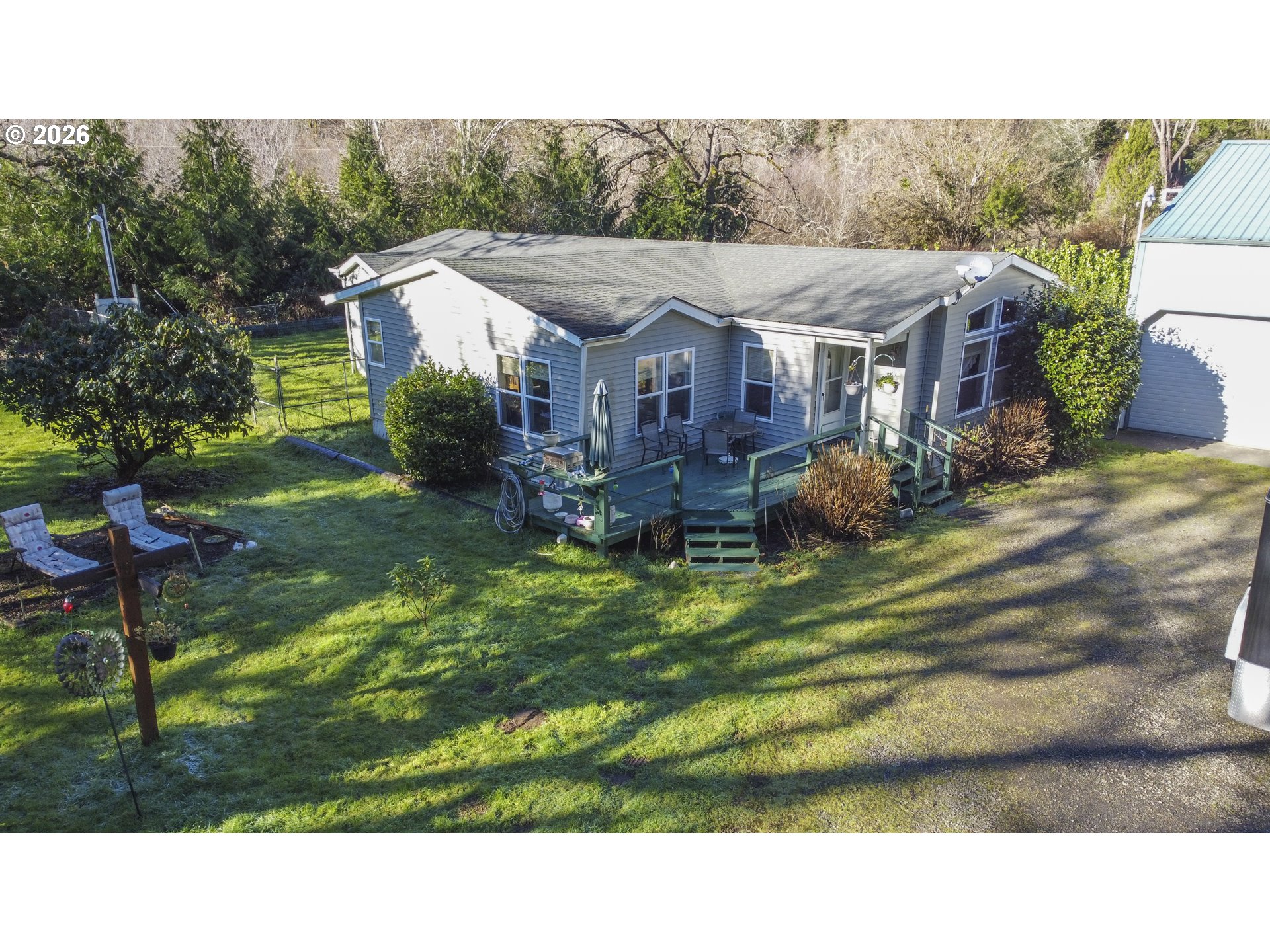 9580 North Fork Siuslaw Road Florence, OR 97439 - Photo 4 of 48 a backyard of a house with table and chairs