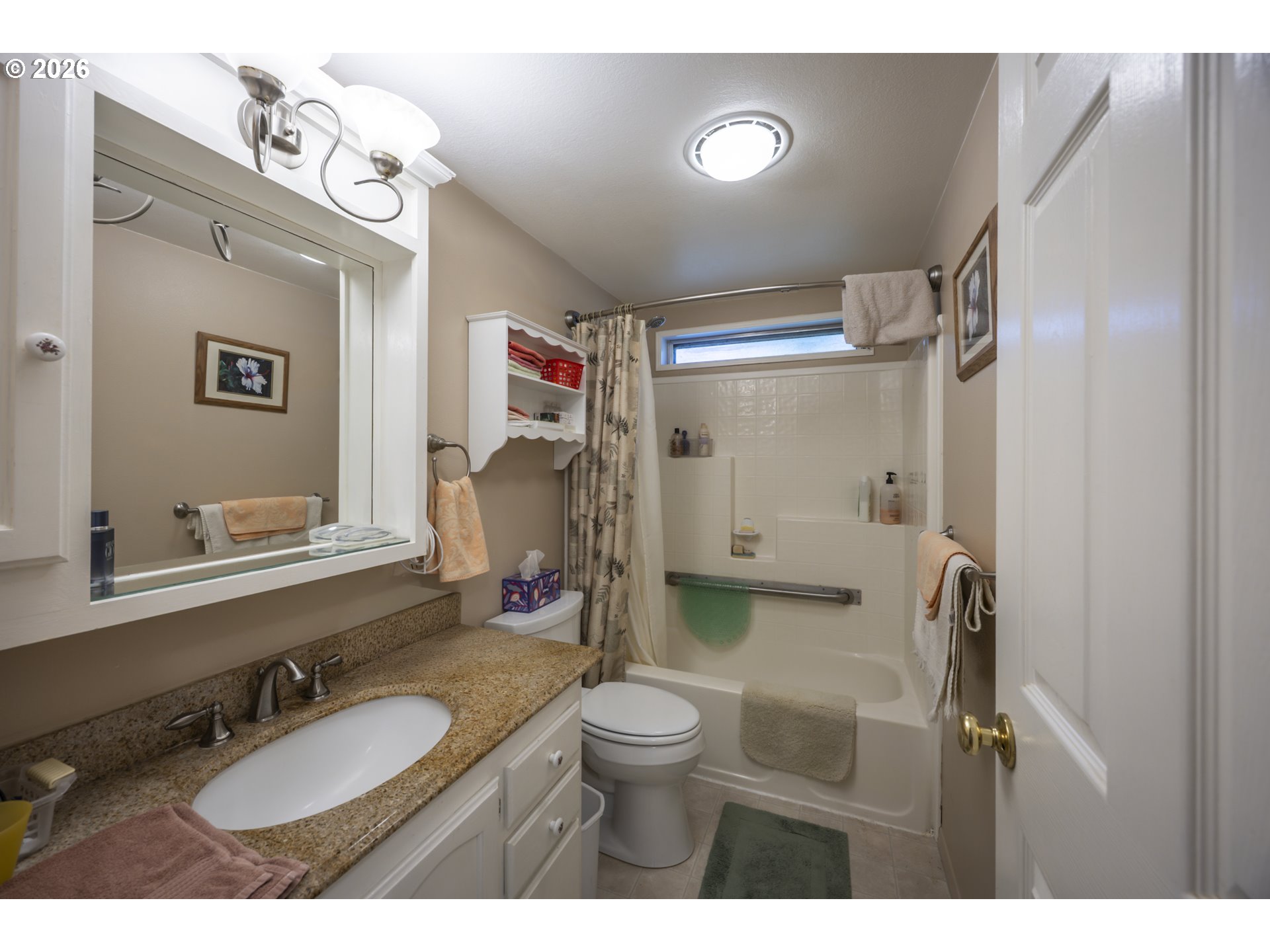 9580 North Fork Siuslaw Road Florence, OR 97439 - Photo 45 of 48 a bathroom with a granite countertop sink toilet a mirror a vanity and shower