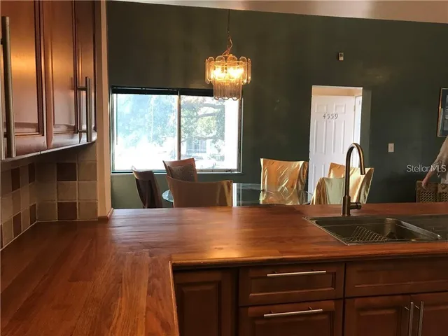 a view of kitchen with granite countertop cabinets and wooden floor