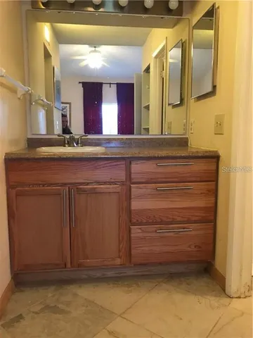 a bathroom with a sink vanity and mirror