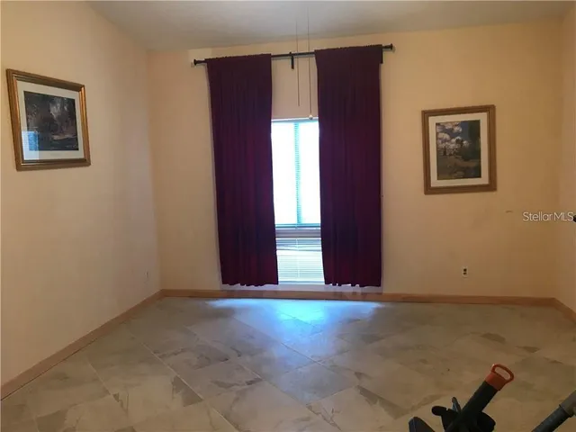 an empty room with windows and closet