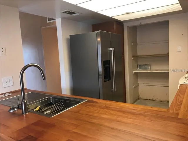 a kitchen with a refrigerator and a table