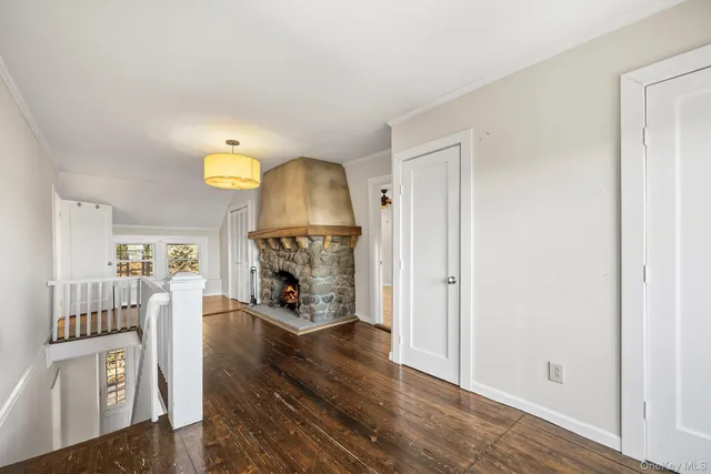 a view of a livingroom with wooden floor and a fireplace