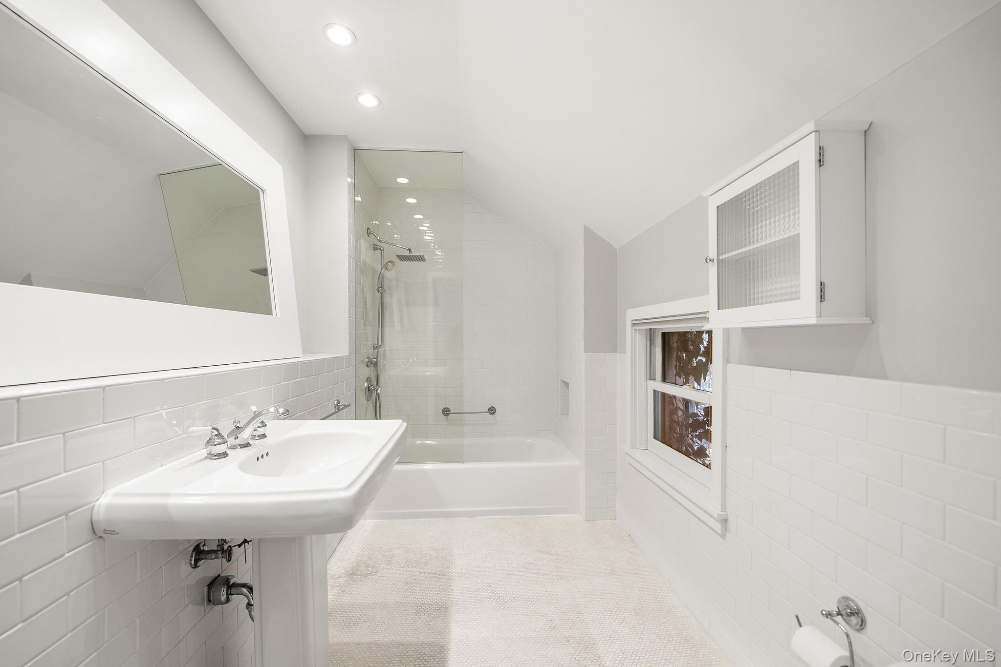 1007 Rte 9W Nyack, NY 10960 - Photo 27 of 45 a bathroom with a bathtub shower sink and mirror