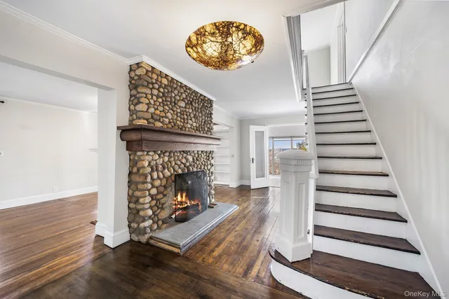 a view of a livingroom with wooden floor and a fireplace