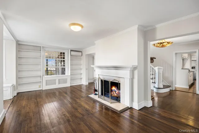 a view of an empty room with a fireplace and a window