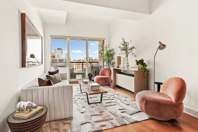 a living room with furniture and a chandelier