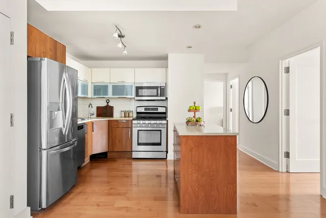 a kitchen with stainless steel appliances a refrigerator a stove and a refrigerator