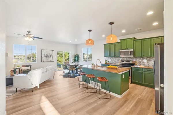 a living room with kitchen island furniture and a wooden floor