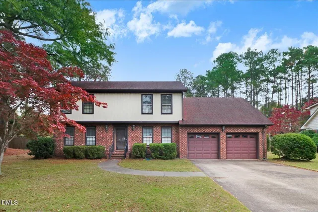 a front view of a house with a garden and plants