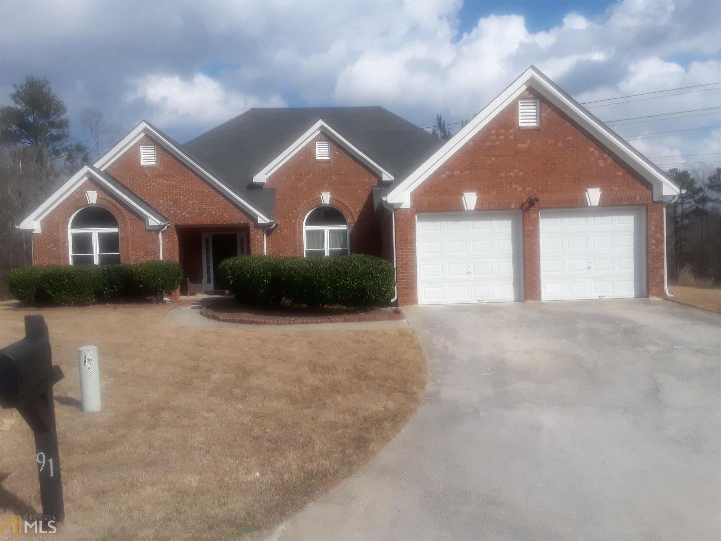 91 Renee Way Fayetteville, GA 30215 - Photo 1 of 1 a front view of a house with a yard and garage