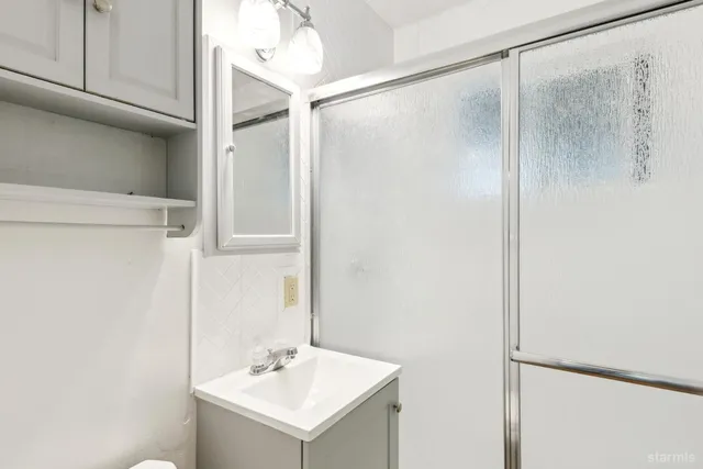 a bathroom with a shower and a sink