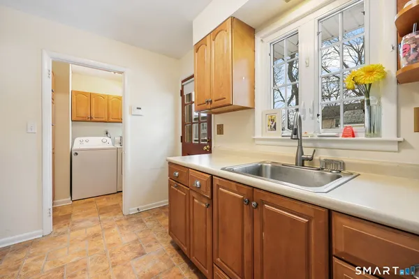 a kitchen with stainless steel appliances granite countertop a sink and a window