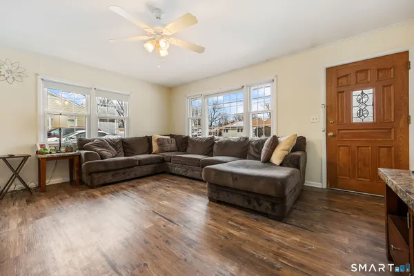 a living room with furniture and a wooden floor