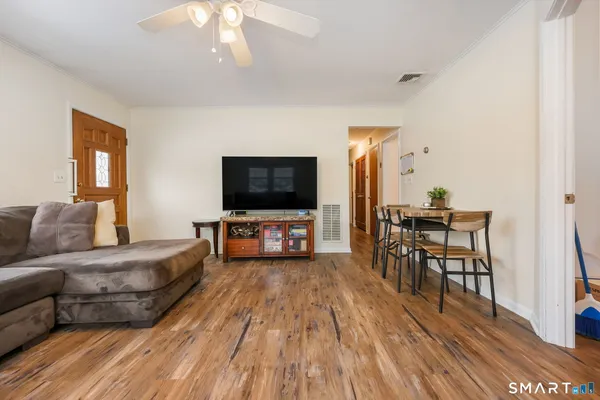a living room with furniture and a flat screen tv