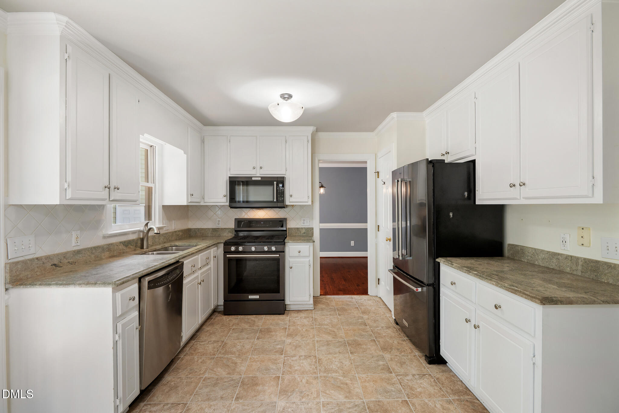 4712 Forest Highland Drive Raleigh, NC 27604 - Photo 12 of 53 a kitchen with stainless steel appliances granite countertop a refrigerator stove and sink