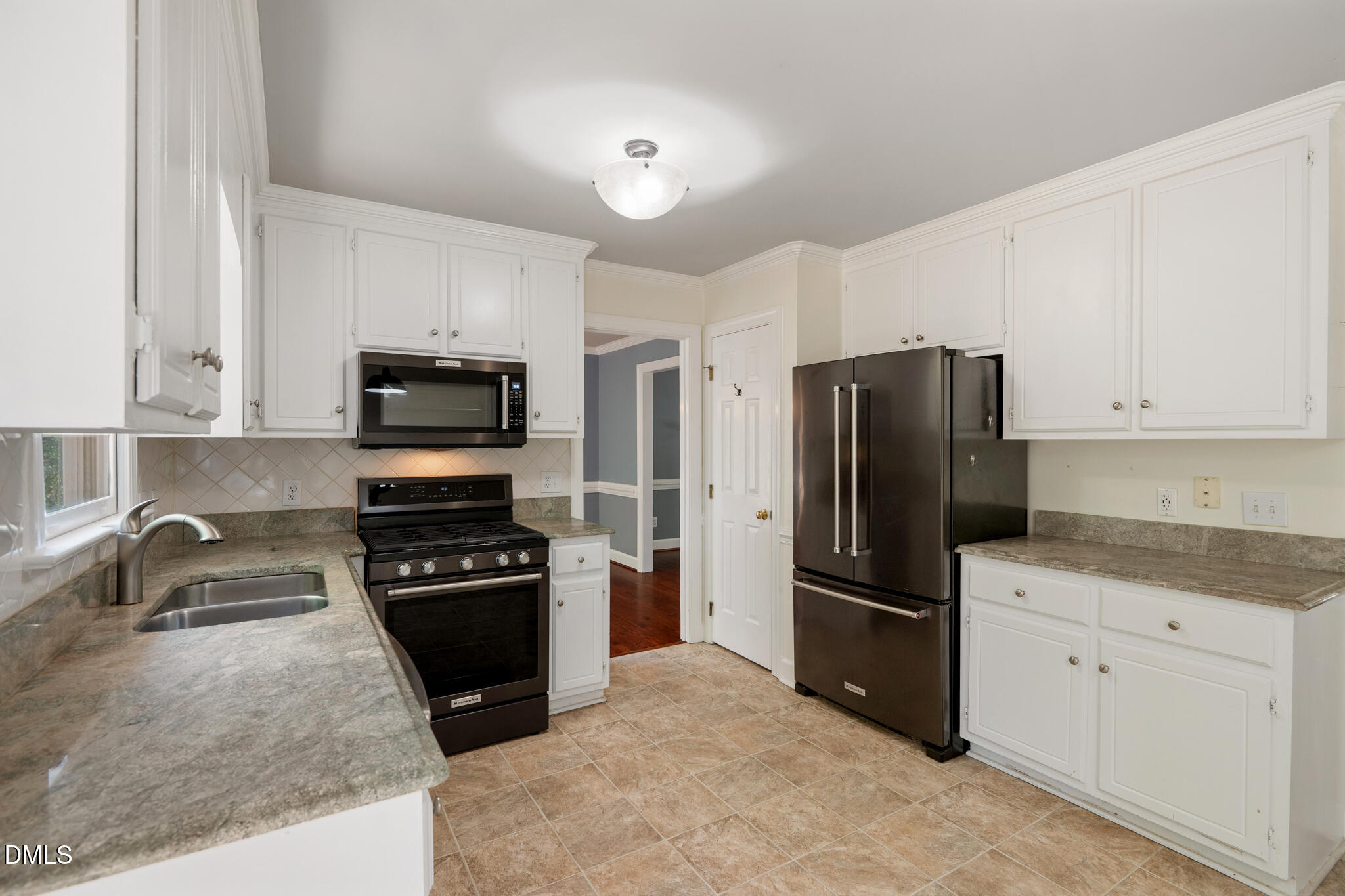 4712 Forest Highland Drive Raleigh, NC 27604 - Photo 13 of 53 a kitchen with granite countertop a refrigerator and a sink
