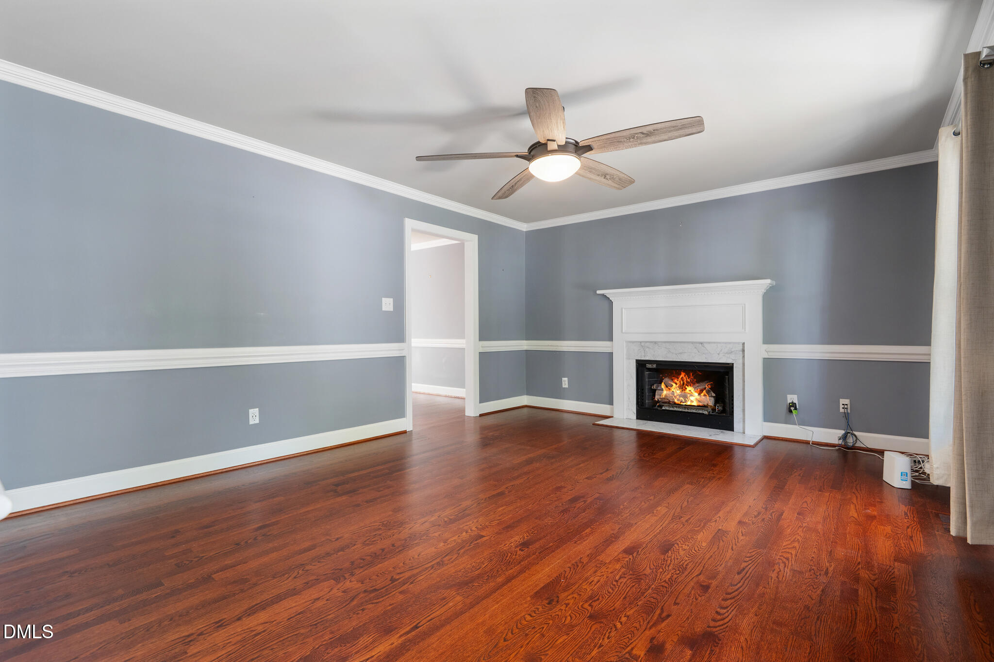 4712 Forest Highland Drive Raleigh, NC 27604 - Photo 9 of 53 a view of an empty room with wooden floor fireplace and a window