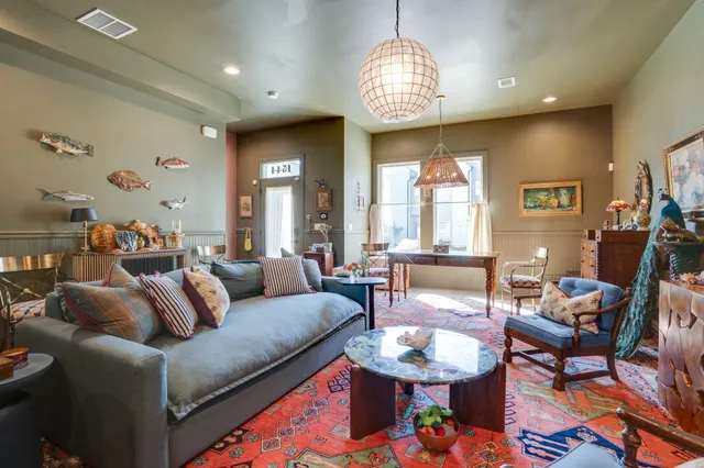 a living room with furniture a chandelier and a chandelier