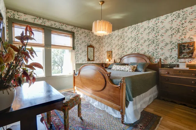 a bedroom with a bed and a chandelier