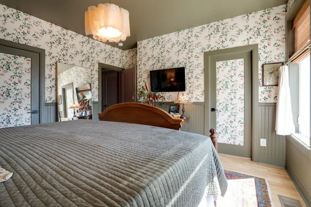 a bedroom with a bed and a flat screen tv