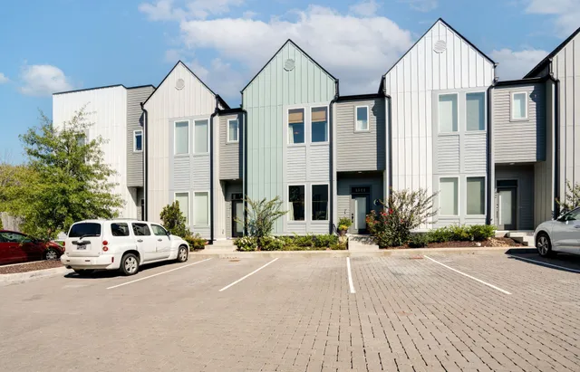 a view of multiple houses with a yard