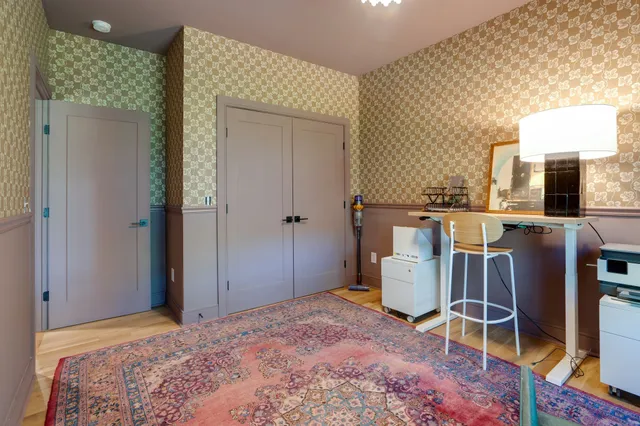 a bedroom with a bed and a mirror