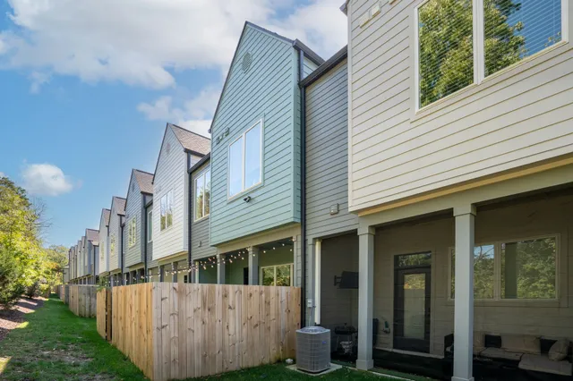a view of a house with wooden fence