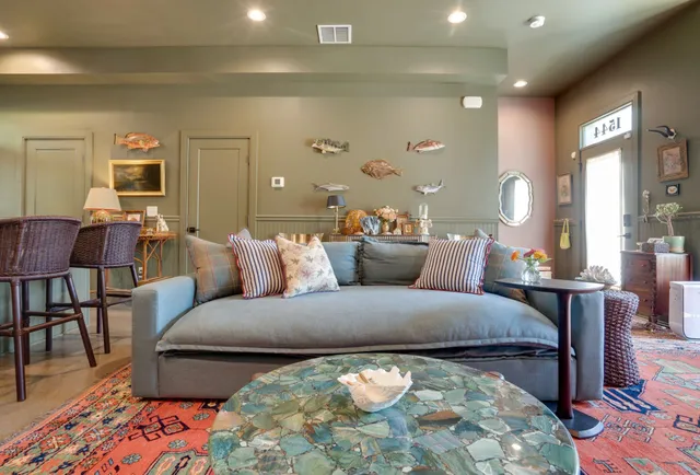 a large bedroom with a bed and wooden floor