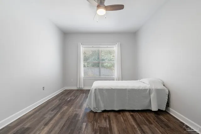 a bed sitting in a bedroom next to a window