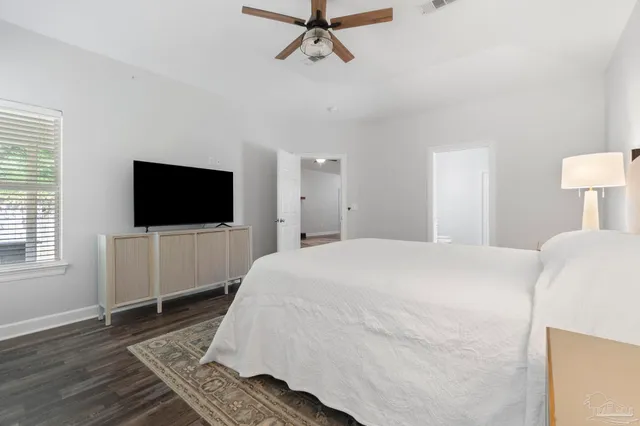 a bedroom with a flat screen tv and a bed