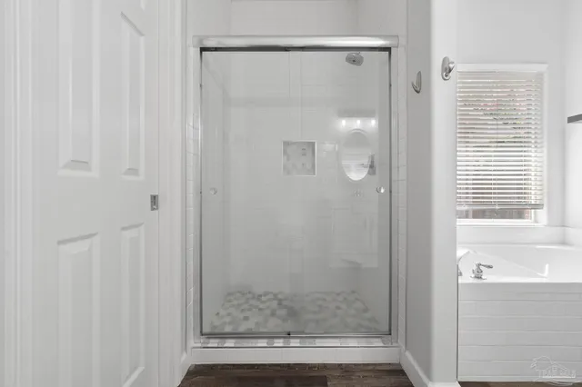 a bathroom with a glass shower door