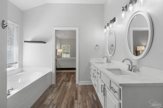a bathroom with a double vanity sink and a mirror