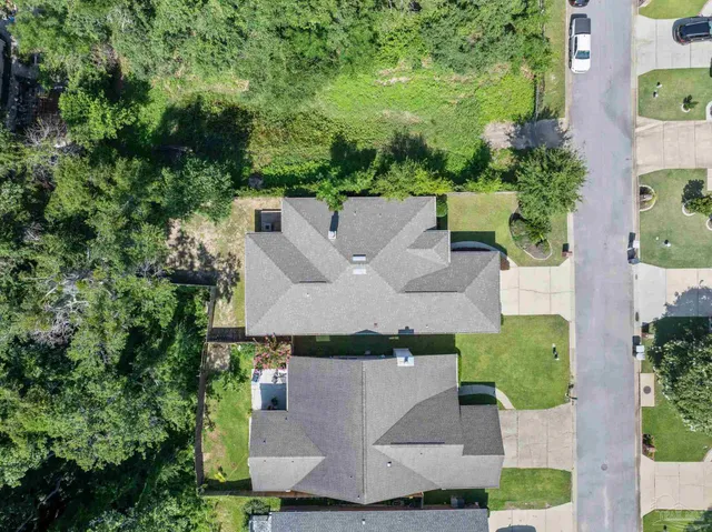 an aerial view of a house with swimming pool and garden