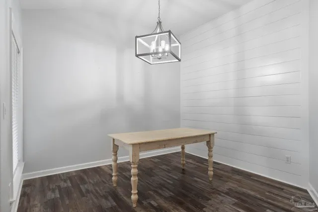 a view of a room with wooden floor wooden door and windows