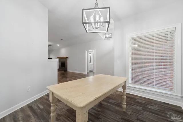 a view of a kitchen with a table and a window