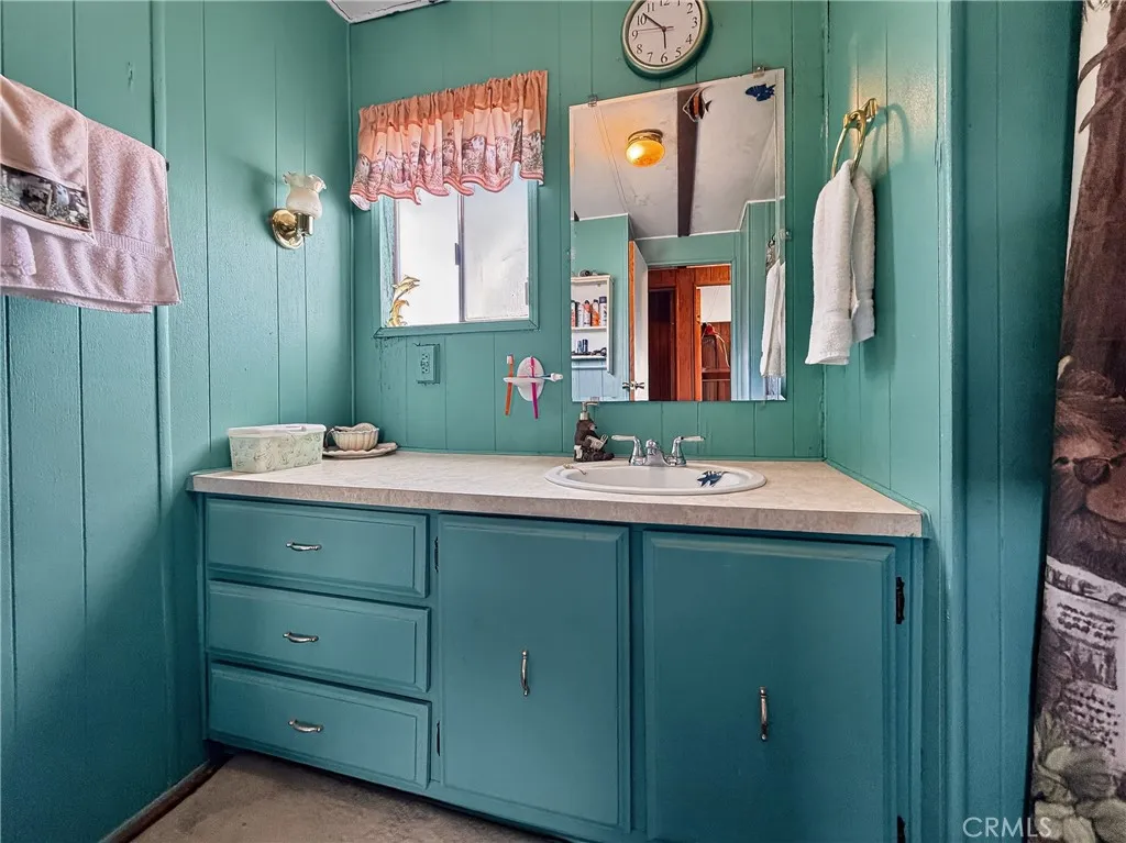 230 Patterson Road Rosamond, CA 93560 - Photo 14 of 18 a bathroom with a sink and mirror