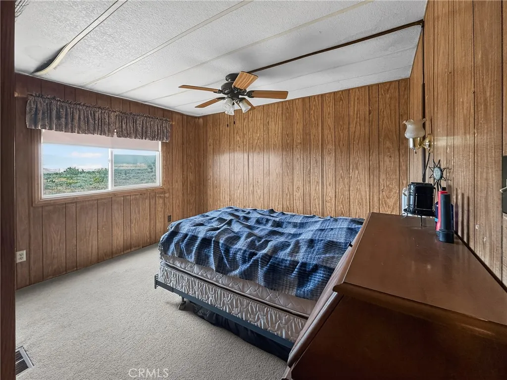 230 Patterson Road Rosamond, CA 93560 - Photo 15 of 18 a bed sitting in a spacious bedroom next to a window